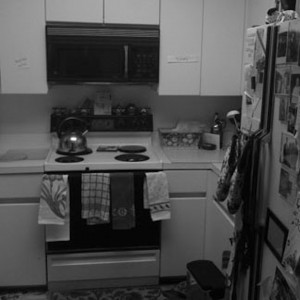 Before—The kitchen is drab and cluttered