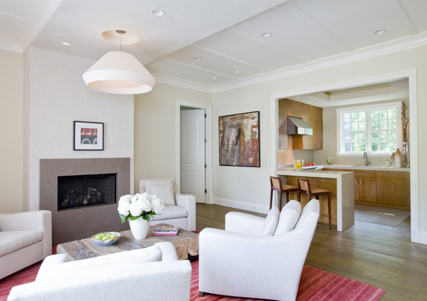 A reclaimed wood table and flush fireplace complete this open concept In-Law suite