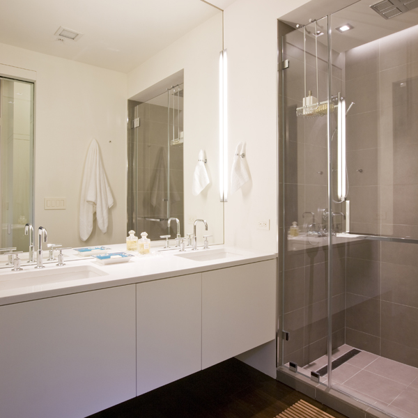 A floating vanity has been paired with ideal lighting, part of a functional contemporary bathroom in this second home for an international power couple