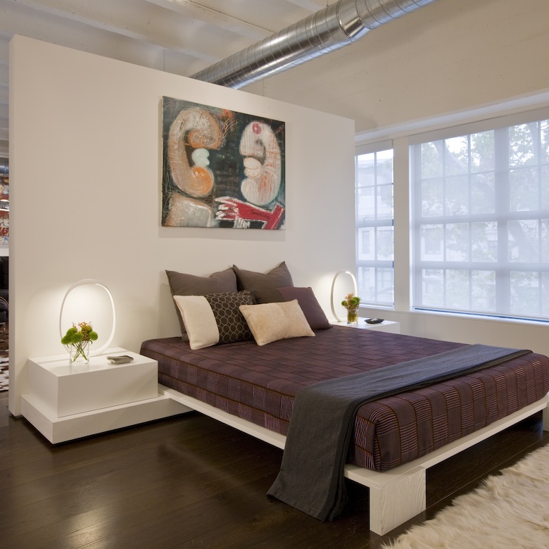 This renovated apartment, second home for an international power couple, included custom contemporary furniture, like this bed, integrated into this room divider.