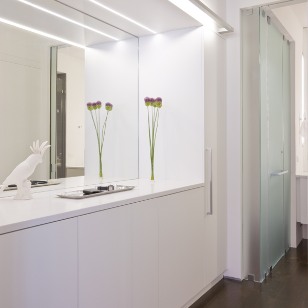 The walk-in closet of this Washington, DC loft, second home for an international power couple, includes a counter space for folding clothes or packing suitcases.