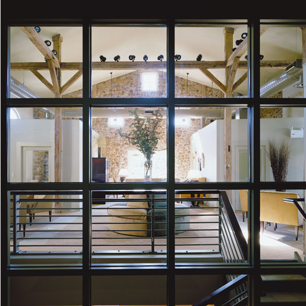 Studio Santalla used track lighting on the original timber beams in the renovation of this residential clubhouse and visitor center.