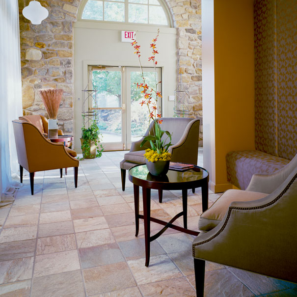 Built in seating and exposed stone create an elegant yet contemporary entrance to this clubhouse renovation by DC architecture firm, Studio Santalla