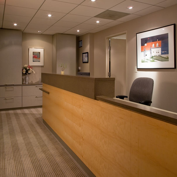 Great lighting and wood finishes complete the modern reception desk by DC Interior Design firm Studio Santalla