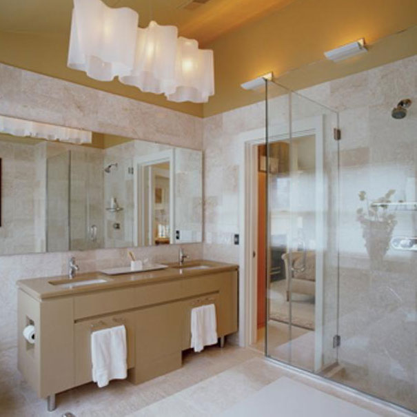A custom vanity and glass shower complete this bathroom by Washington, DC interior design firm, Studio Santalla