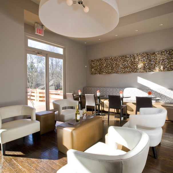 Contemporary pub with banquette seating and modern light fixture