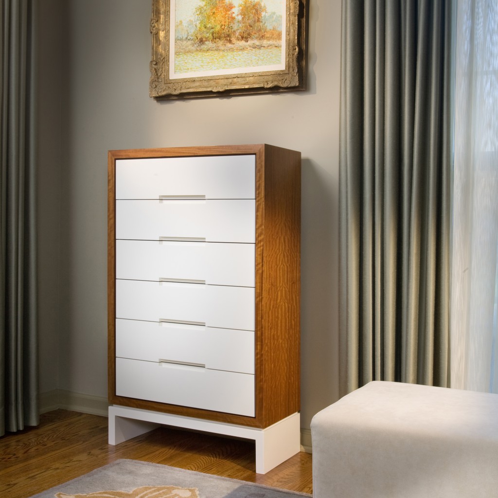 This custom designed dresser serves as a silver chest, housing the client's antique collection.