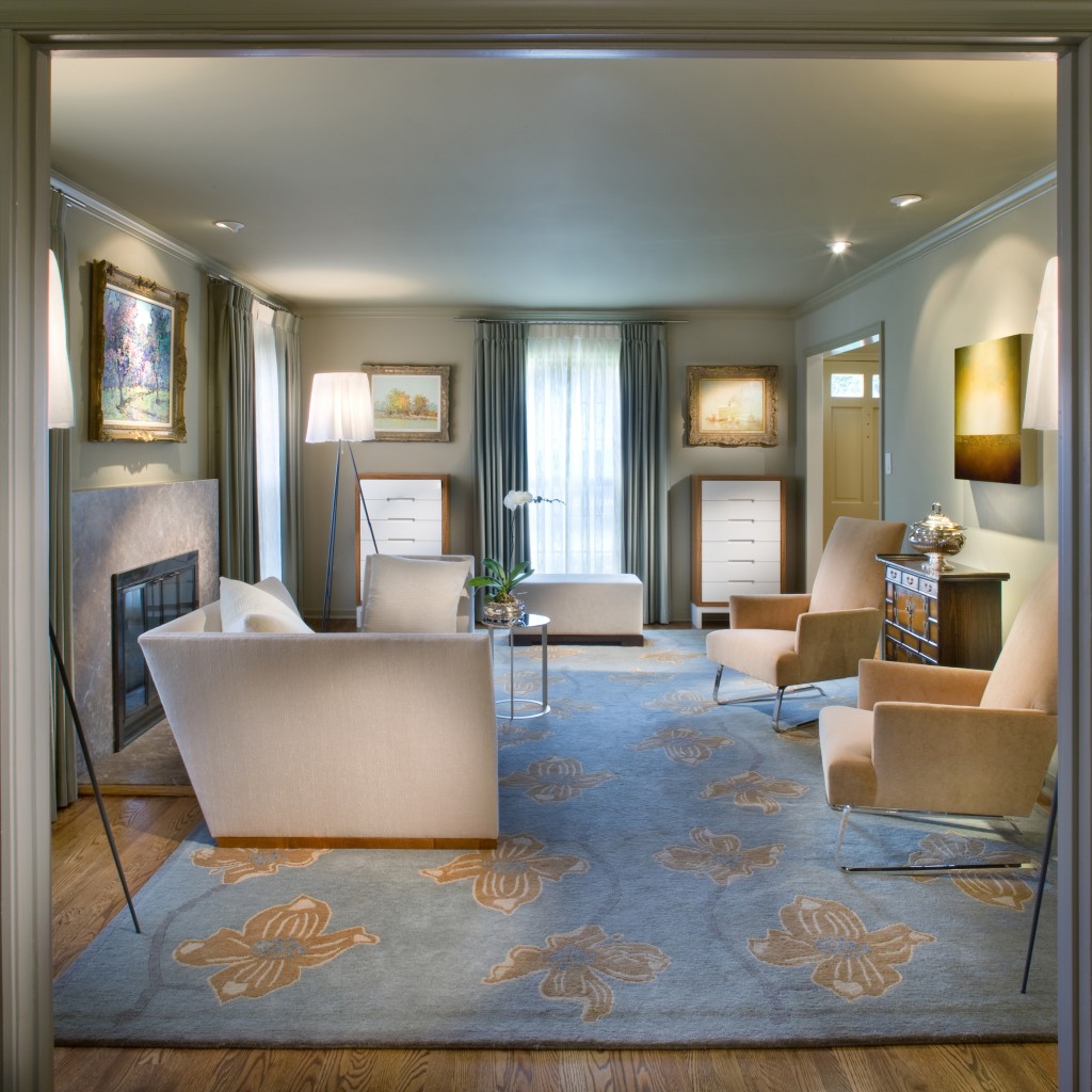 This contemporary sitting room features a custom designed rug and silver chests, accompanied by a luxurious chaise and chairs from Donghia