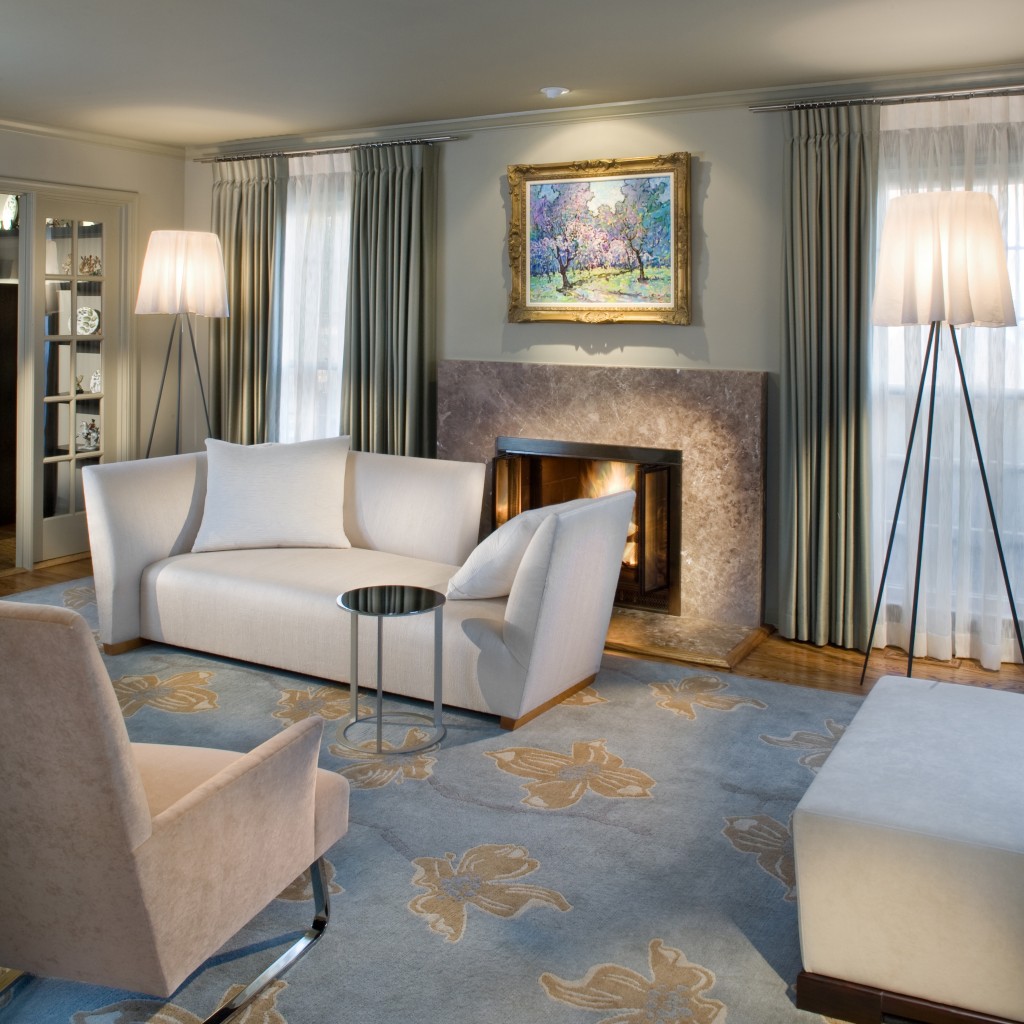 This contemporary sitting room features a custom designed rug and silver chests, accompanied by a luxurious chaise and chairs from Donghia