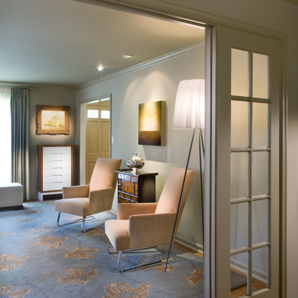 This contemporary sitting room features a custom designed rug and silver chests, accompanied by a luxurious chaise and chairs from Donghia