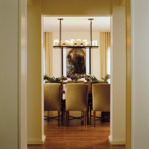Colonnaded dining room with Kevin Reilly Lighting after Studio Santalla renovation