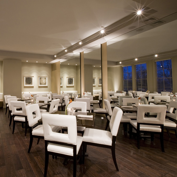 Mirrors create architectural elements in this Contemporary Dining room by Studio Santalla