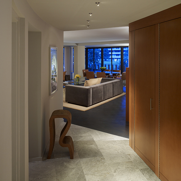 A Frank Gehry stool and LED lighting, flanked by built-in storage, complete this entry, which follows the natural curve of the Watergate Building