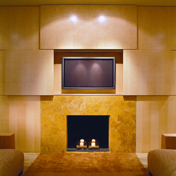 Custom fireplace surround and media center with hidden television designed by contemporary Washington DC architecture and interior design firm, Studio Santalla