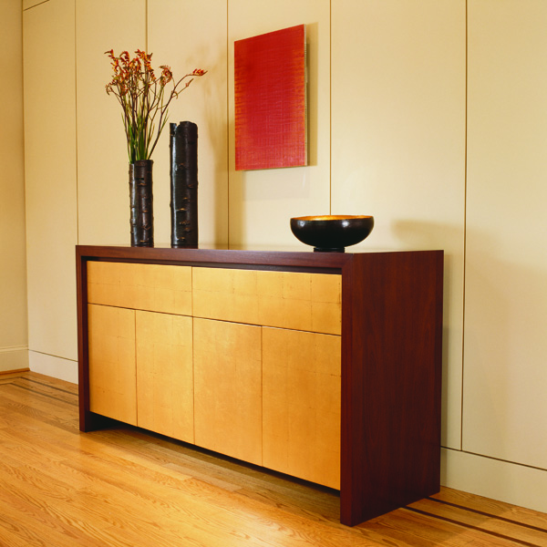 Studio Santalla custom designed this contemporary sideboard with mahogany and gold leaf