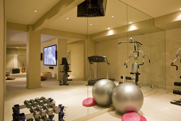 This finished basement by Washington, DC Architect and Interior Design firm Studio Santalla boasts a home gym