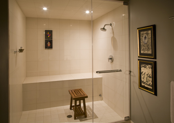 The bathroom of this Washington, DC basement remodel by Studio Santalla included a large and functional glass shower