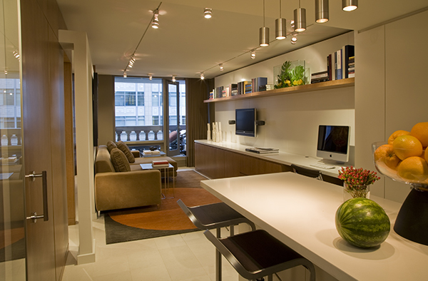 Open and airy, this multipurpose living space with built in storage by Washington, DC architect and interior design firm Studio Santalla is both luxurious and efficient