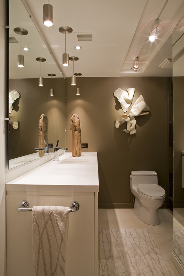 This luxurious bathroom in Washington, DC by Architect and Interior Design Firm Studio Santalla uses bold colors, artwork and dramatic lighting.