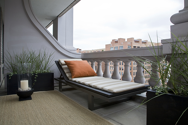 Studio Santalla selected an upscale chaise lounger and sisal rug to complete this zen terrace that offers views of Washington, DC