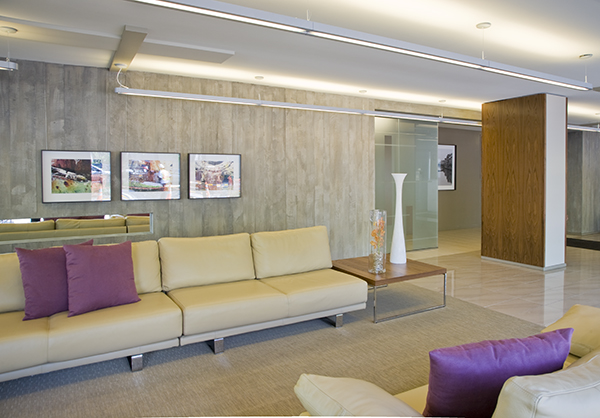 Cement paneling and contemporary furniture give this Condo lobby in Dupont Circle an upscale feel, by Washington, DC Architecture and Interior Design firm Studio Santalla