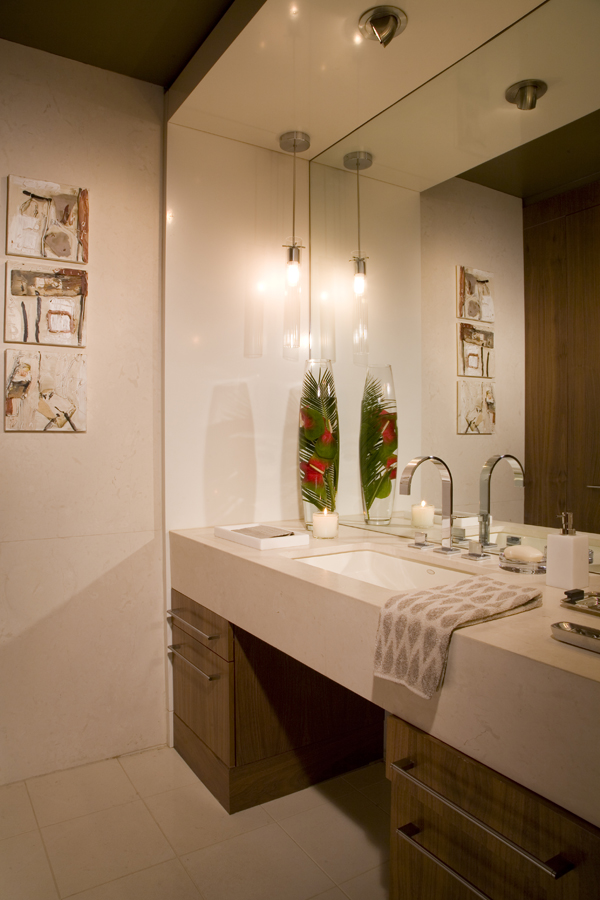 The thick vanity and pendant lighting make a modern statement in this bathroom by Washington, DC architecture and interior design firm Studio Santalla