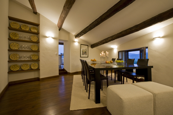 Exposed beams are the highlight of the dining room in this renovation by Washington, DC Architect and Interior design firm Studio Santalla.