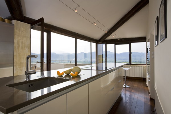 A view of the French countryside from the modern kitchen of this renovation by Washington, DC Architect and Interior Design Firm Studio Santalla