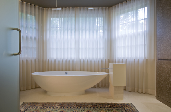 Elegant soaking tub in his and hers (jack and jill) master bathroom by Washington, DC Architect and Interior Design Firm Studio Santalla 