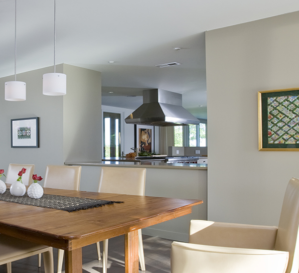 Contemporary dining room with kitchen pass through on the Eastern Shore by Washington, DC Architecture and Interior Design firm Studio Santalla