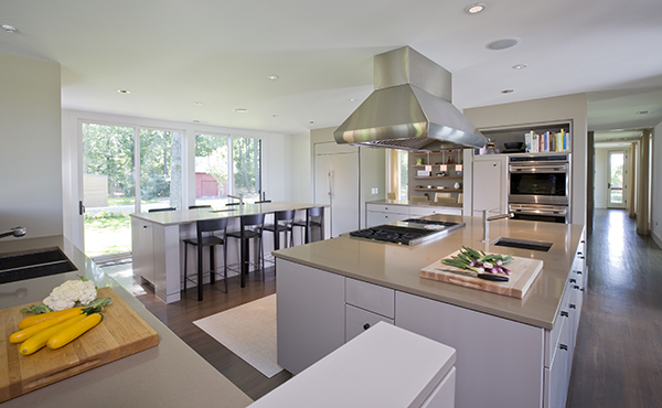 Massive, twin island kitchen in warm neutral colors on the Eastern Shore by Washington, DC Architecture and Interior Design firm Studio Santalla