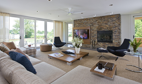 Casually elegant living room with custom designed media center and fireplace on the Eastern Shore by Washington, DC Architecture and Interior Design firm Studio Santalla