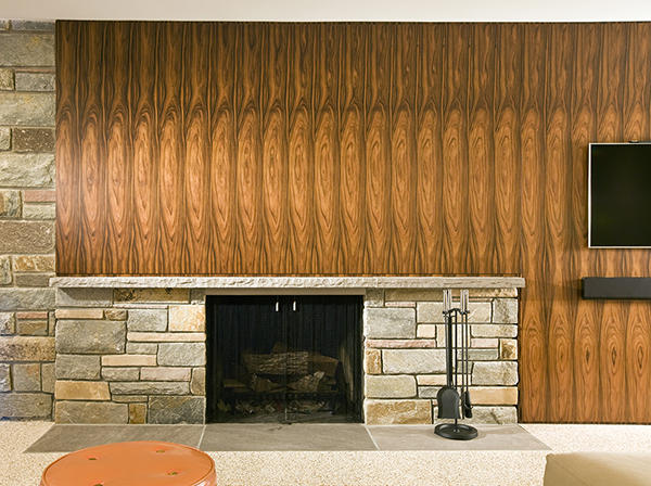 Midcentury inspired asymmetrical basement fireplace feature wall by Washington, DC Architecture and Interior Design firm Studio Santalla