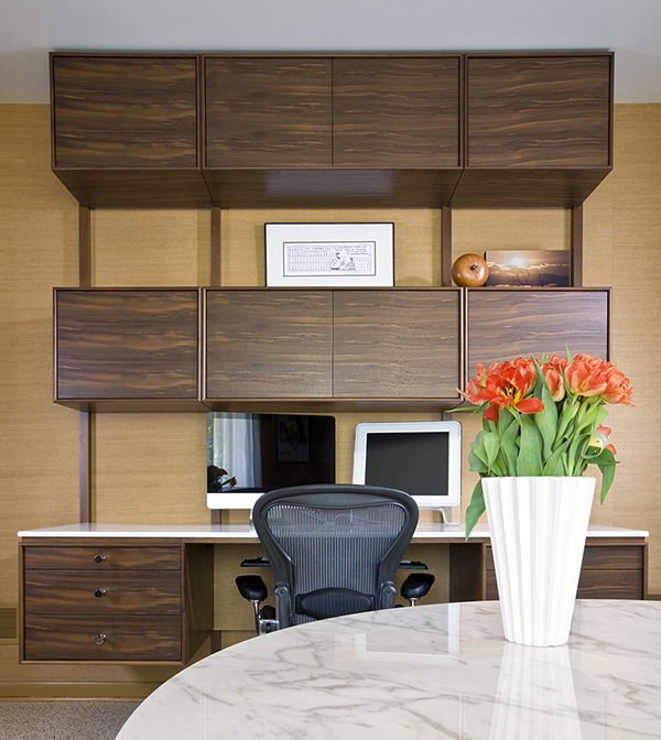 Custom floating desks inspired by midcentury classics provide ample workspace for two in this basement home office by Washington, DC architect and interior design firm Studio Santalla