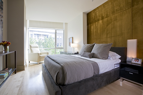 Natural light floods this urban, contemporary bedroom by Washington, DC architecture and interior design firm Studio Santalla