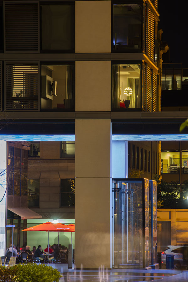 Courtyard View of the apartment provides a peak at the client's contemporary art collection. The globe lights add playfulness